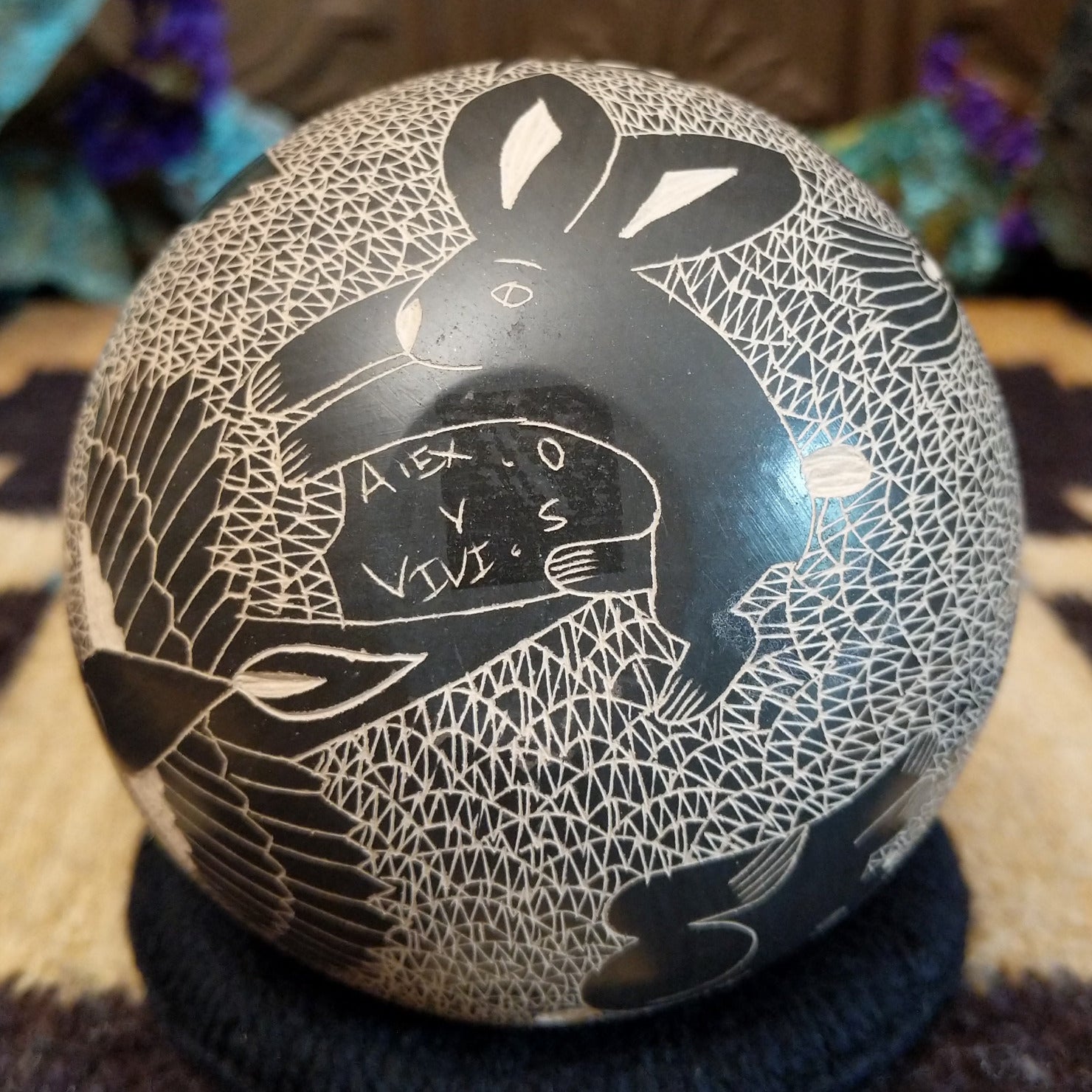 Close up of the artist's engraved signature.