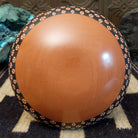 Low-profile Mata Ortiz pottery jar with a geometric checkerboard pattern in black and clay tones, featuring white dotted accents and a squared neck opening.
