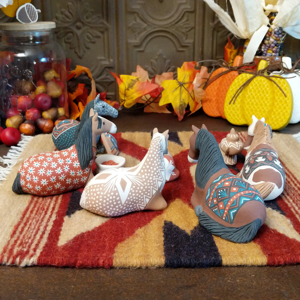 Clay made into horses depicting a traditional nativity scene.