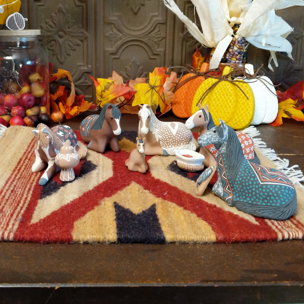 Clay made into horses depicting a traditional nativity scene.