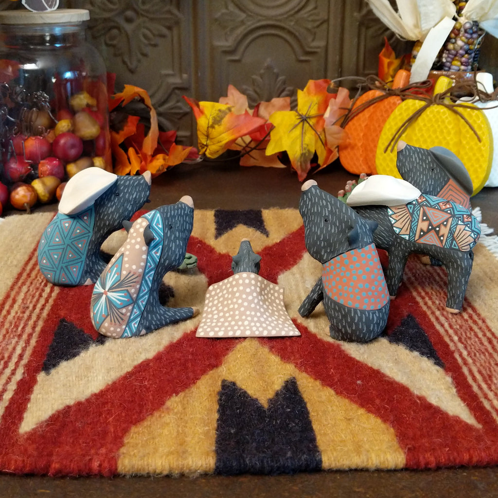 Clay used to create javelinas wearing ponchos and cowboy hats in vibrant colors.
