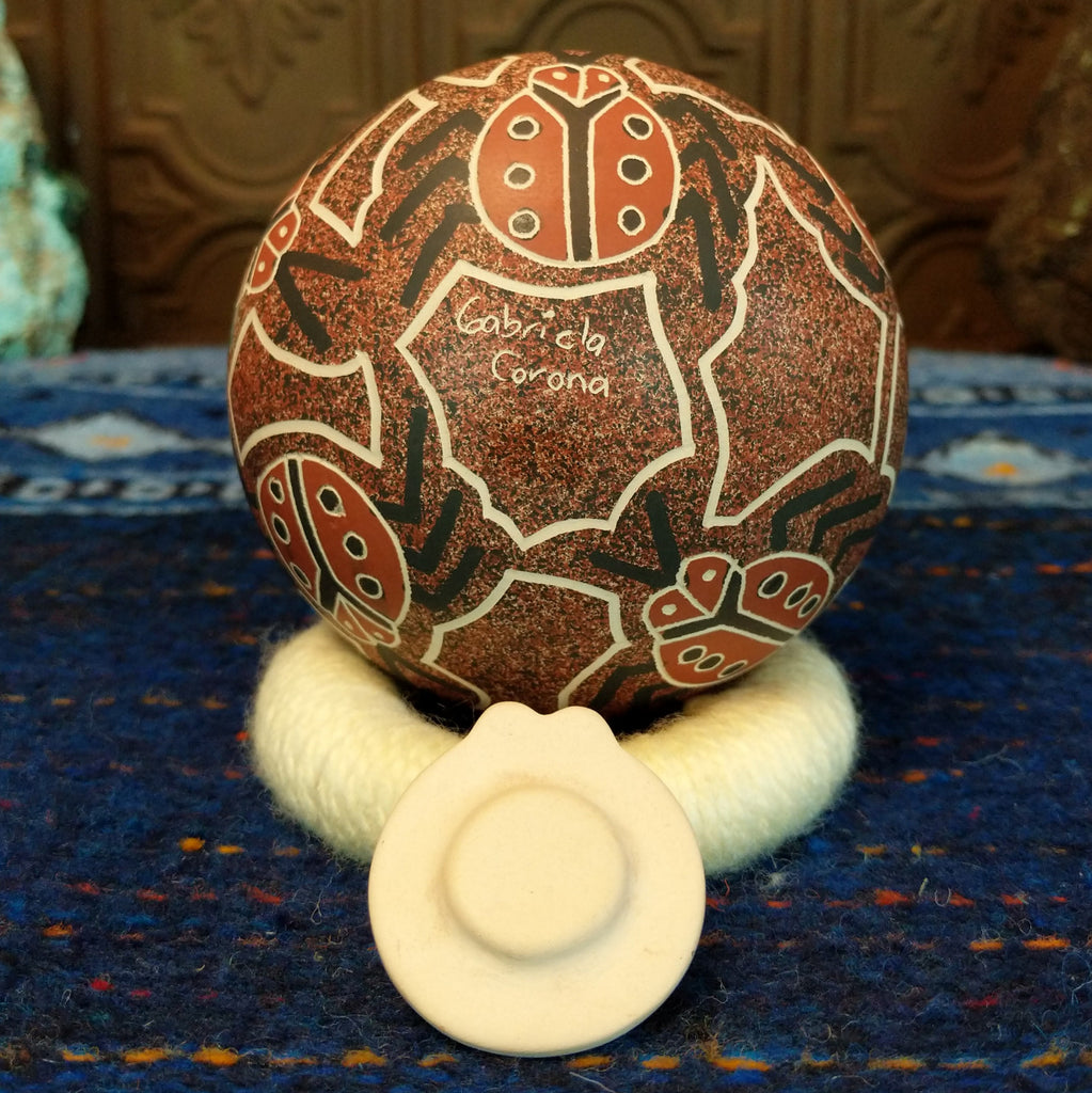 Artisan's signature is etched into the base of the pot.