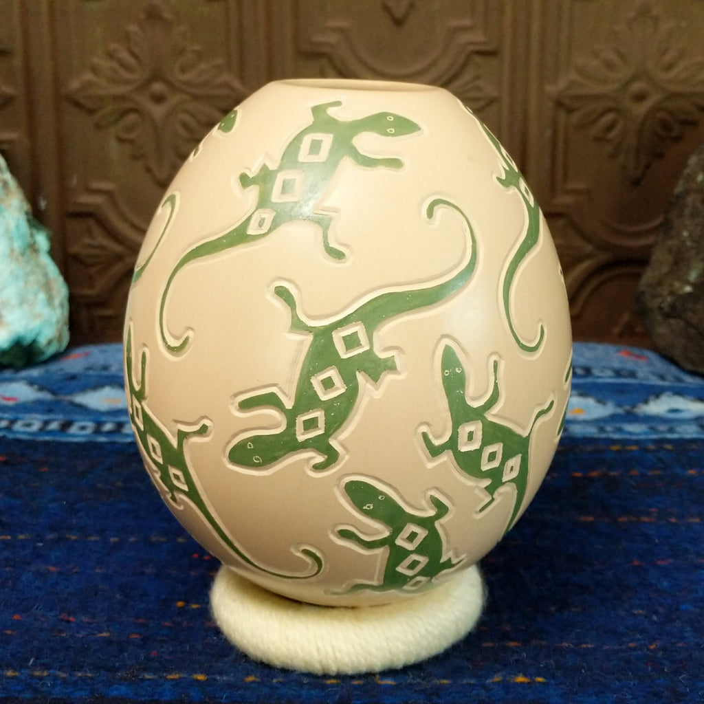 White clay base with green lizard motifs all along it.