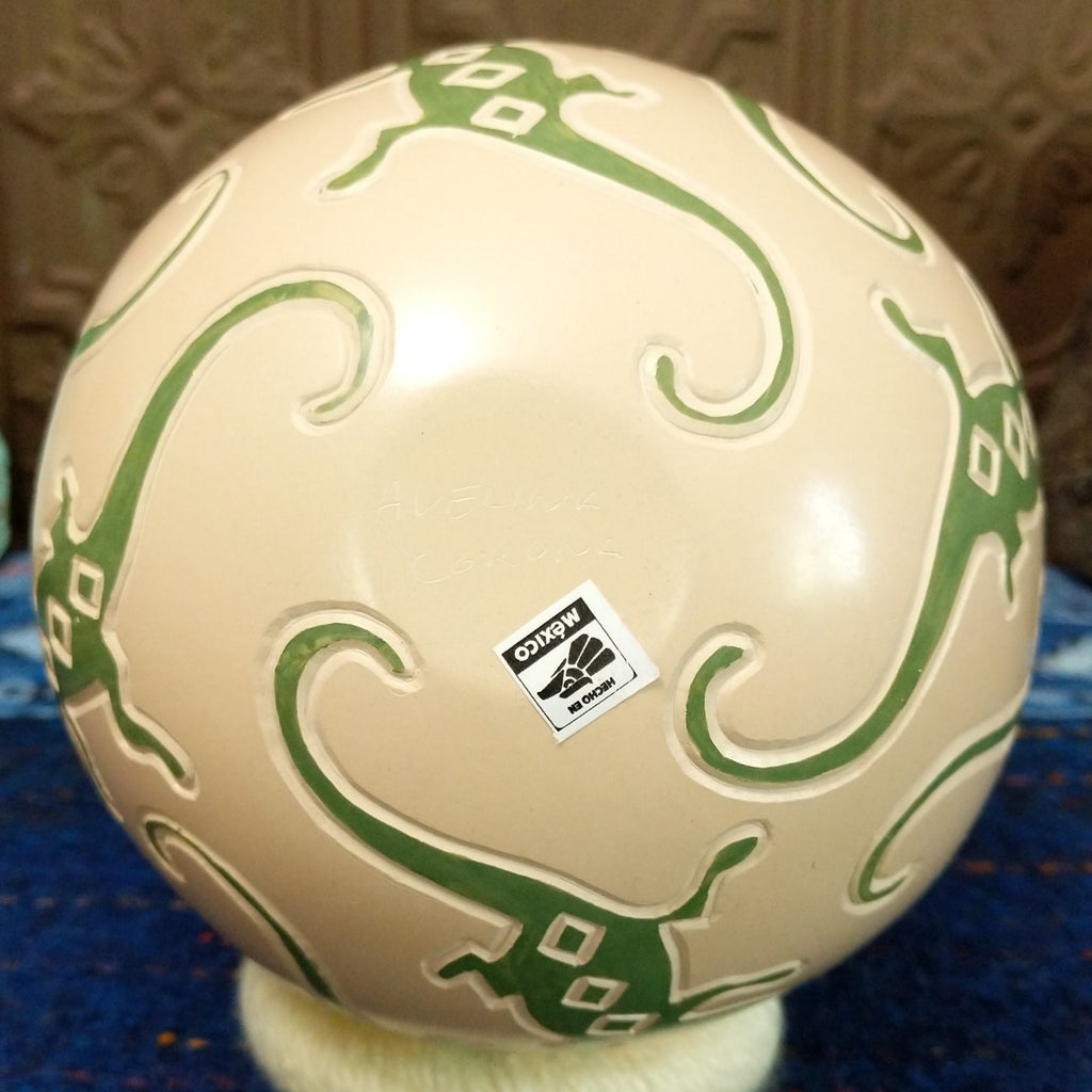 The base of the pottery features the artisan's signature.