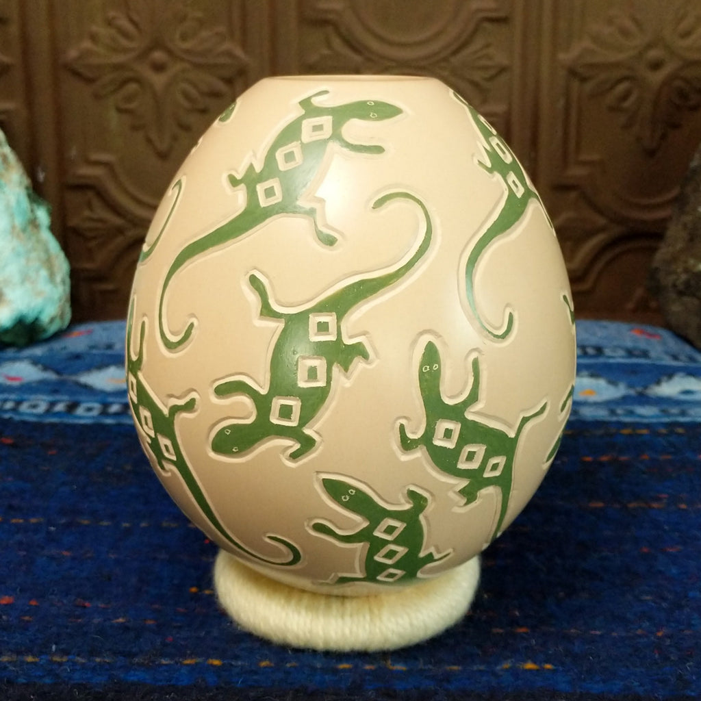 White clay base with green lizard motifs all along it.