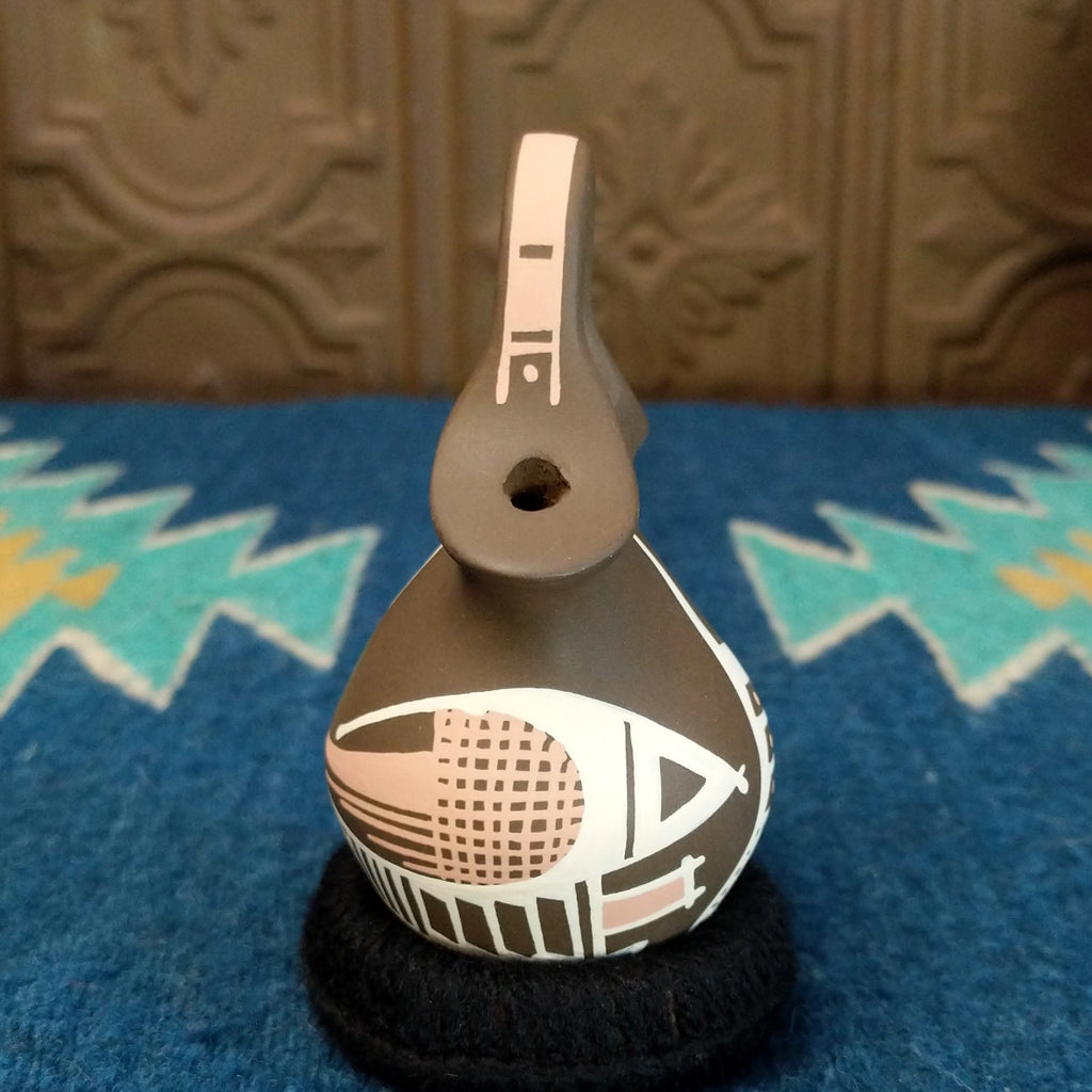 Clay wedding vase in the colors brown, white, and tan.