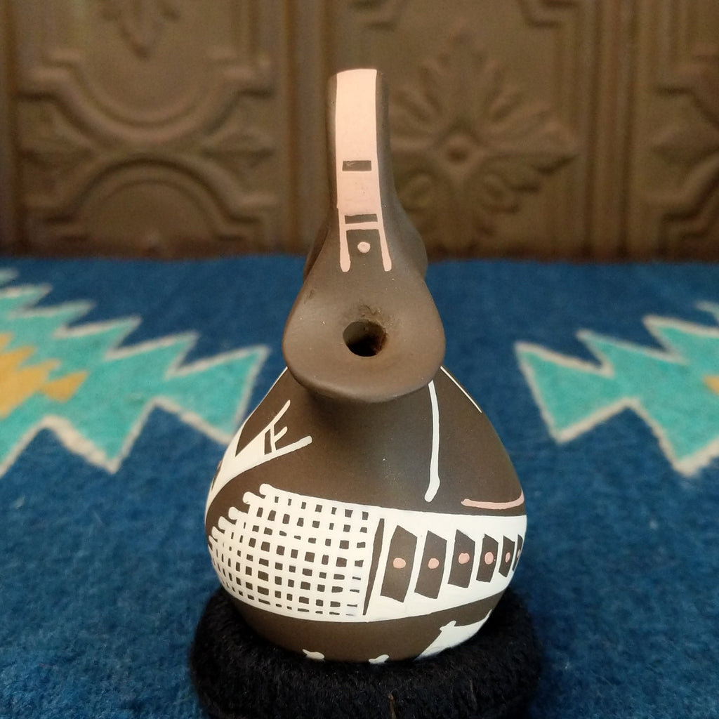 Clay wedding vase in the colors brown, white, and tan.