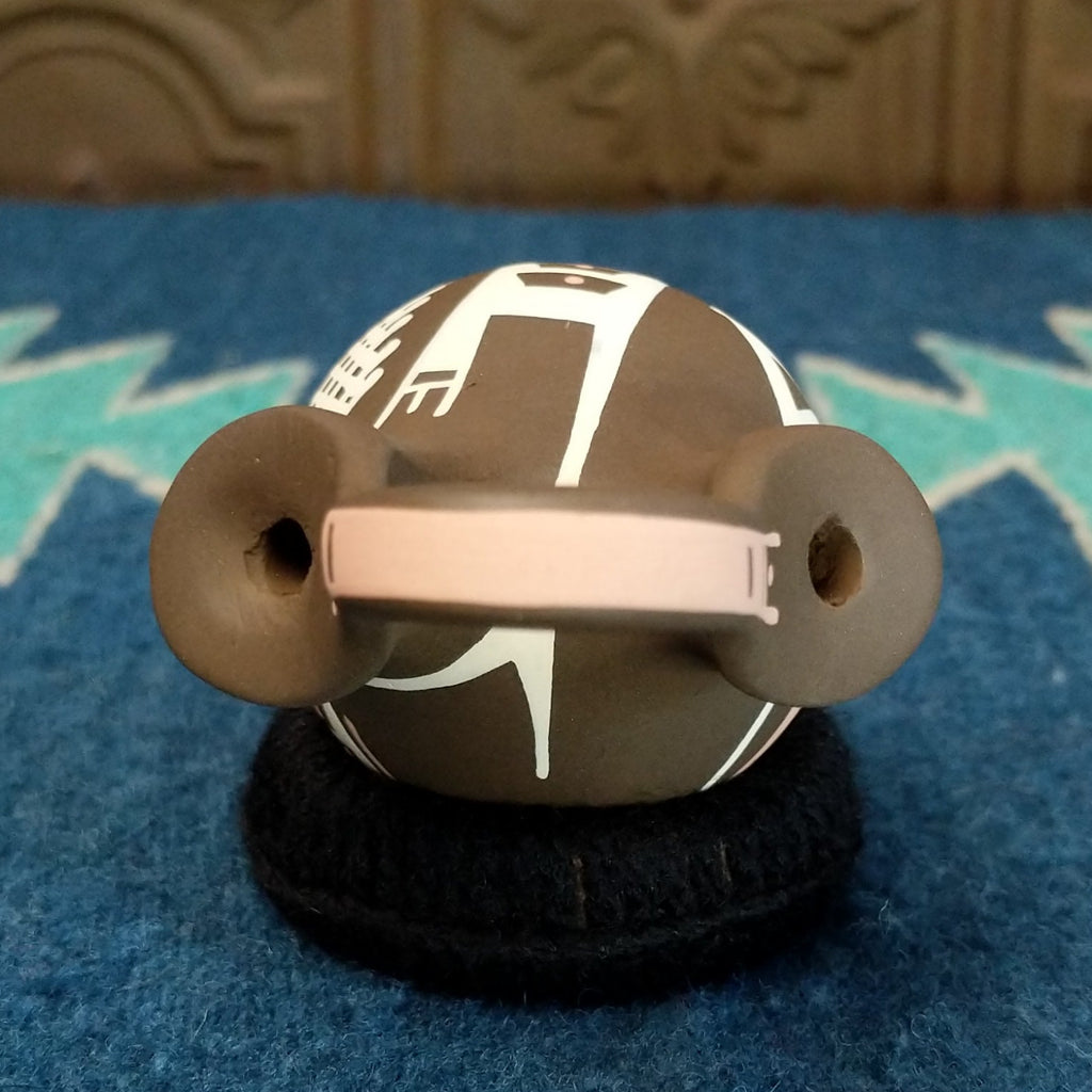 The top features the handle and two spouts.