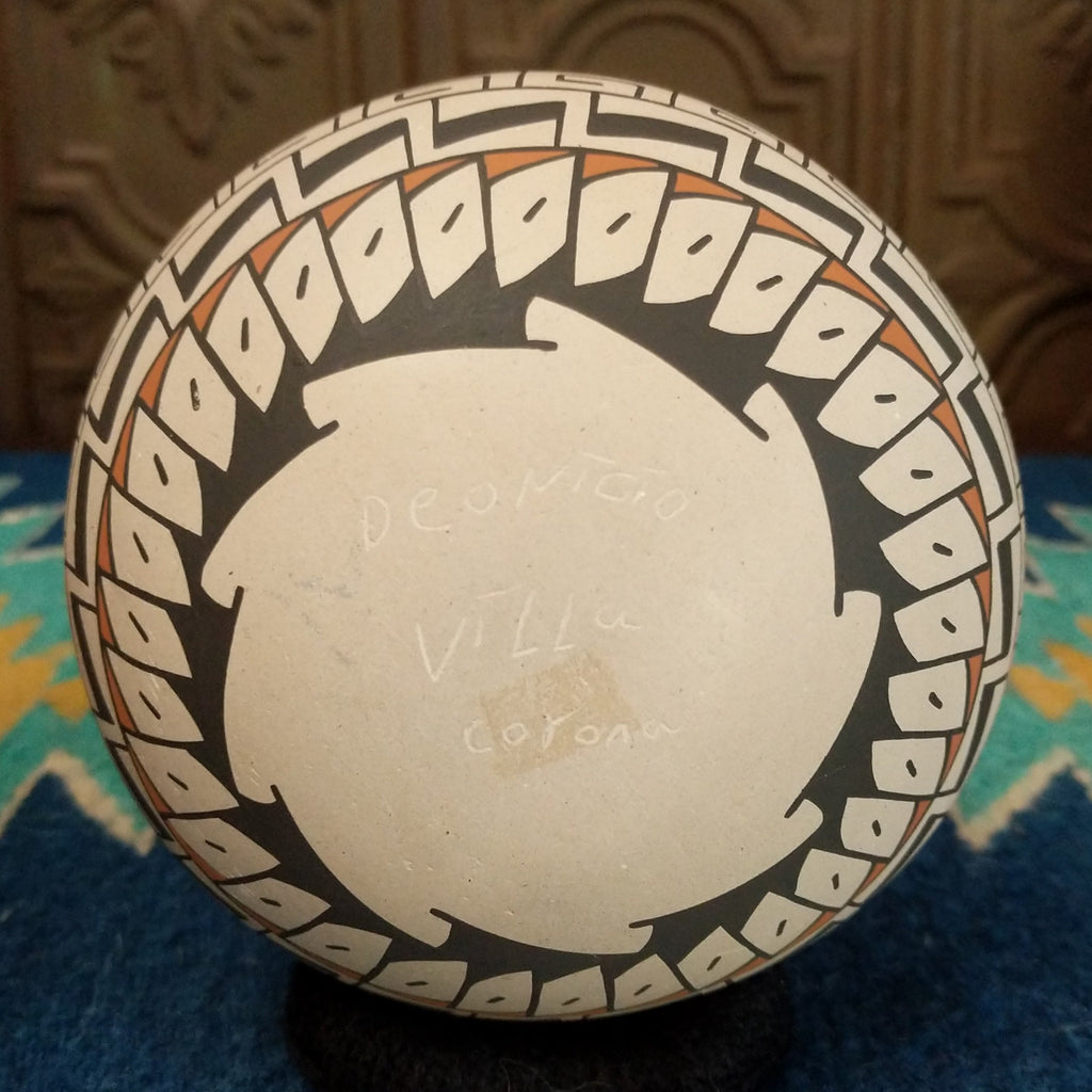 The underside of the pot features the signature.