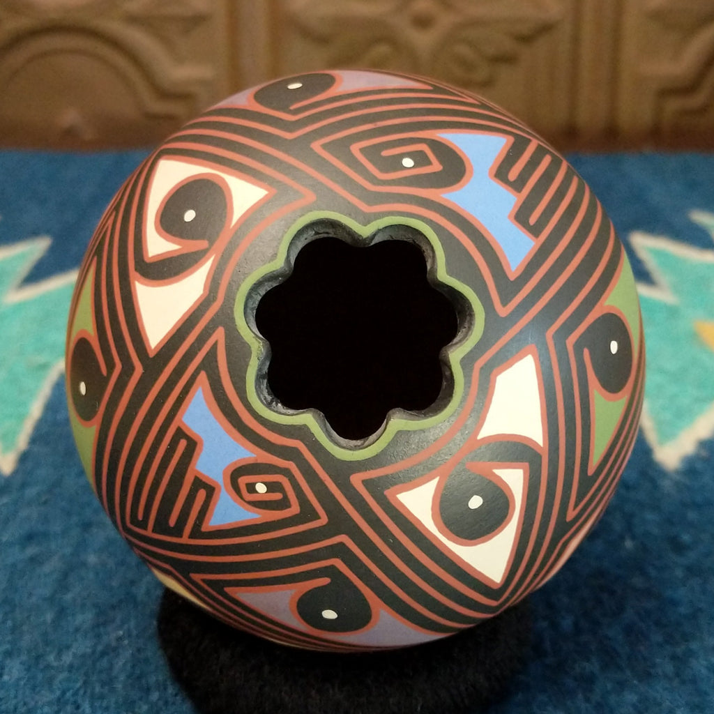 The top of the piece features a floral design.