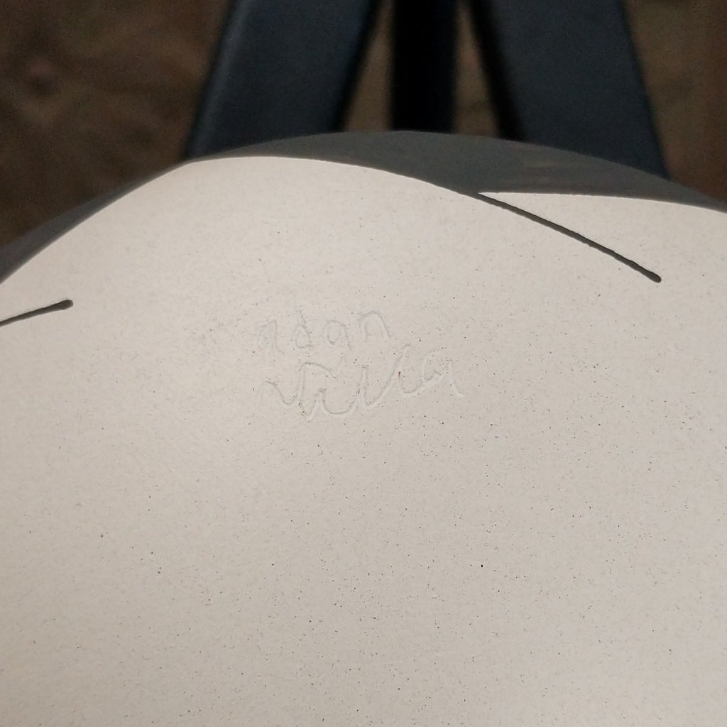 A close-up of the artisan's signature.