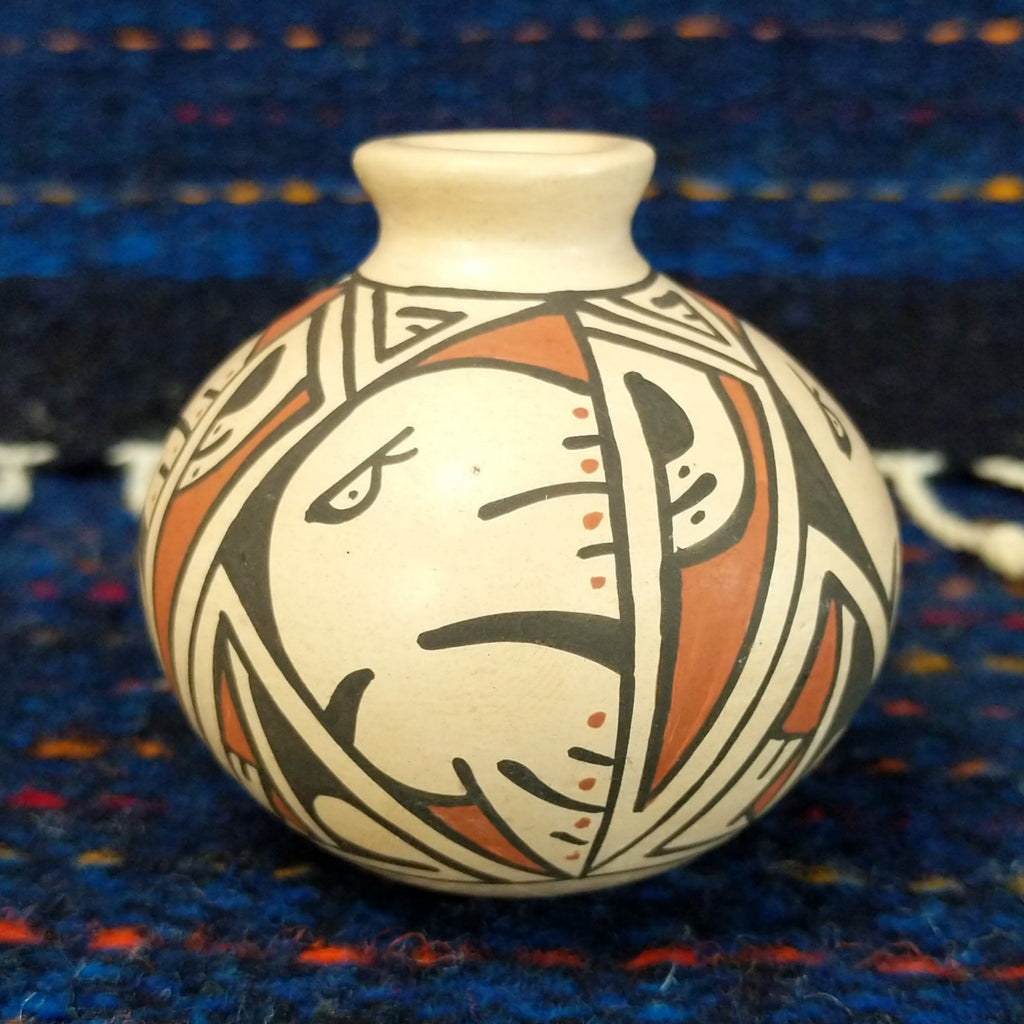 White clay body with a black and red, and a stylized Thunderbird design.