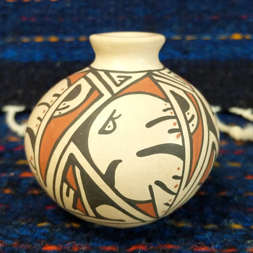 White clay body with a black and red, and a stylized Thunderbird design.