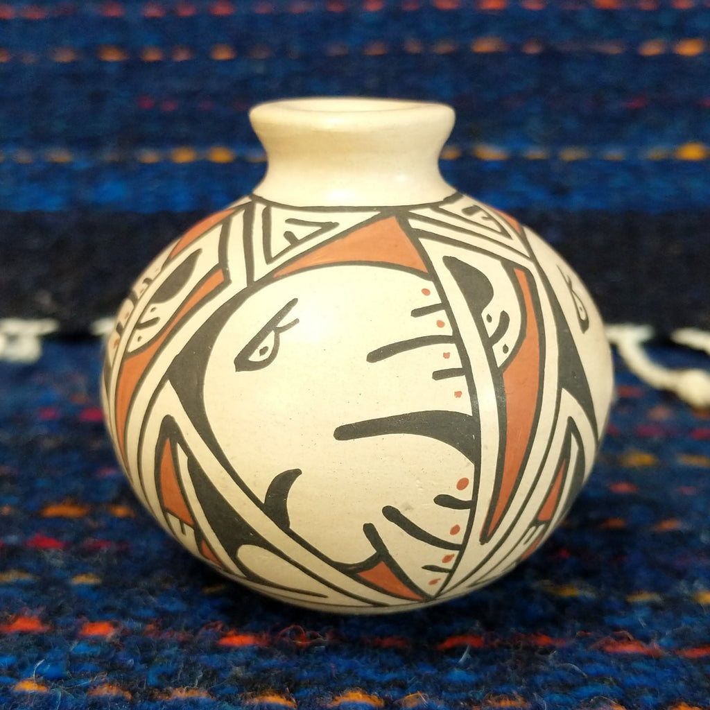 White clay body with a black and red, and a stylized Thunderbird design.