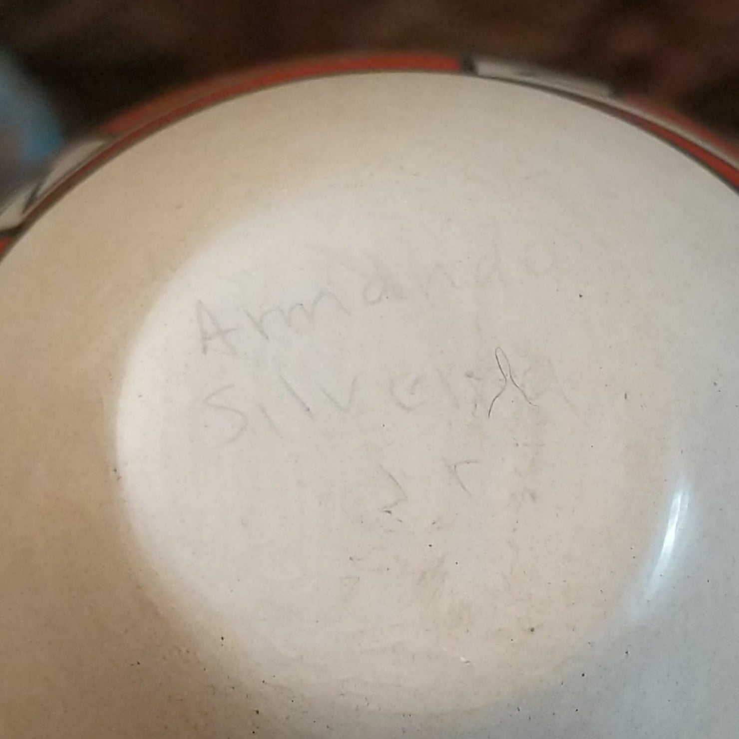 Close up of the artist's engraved signature.