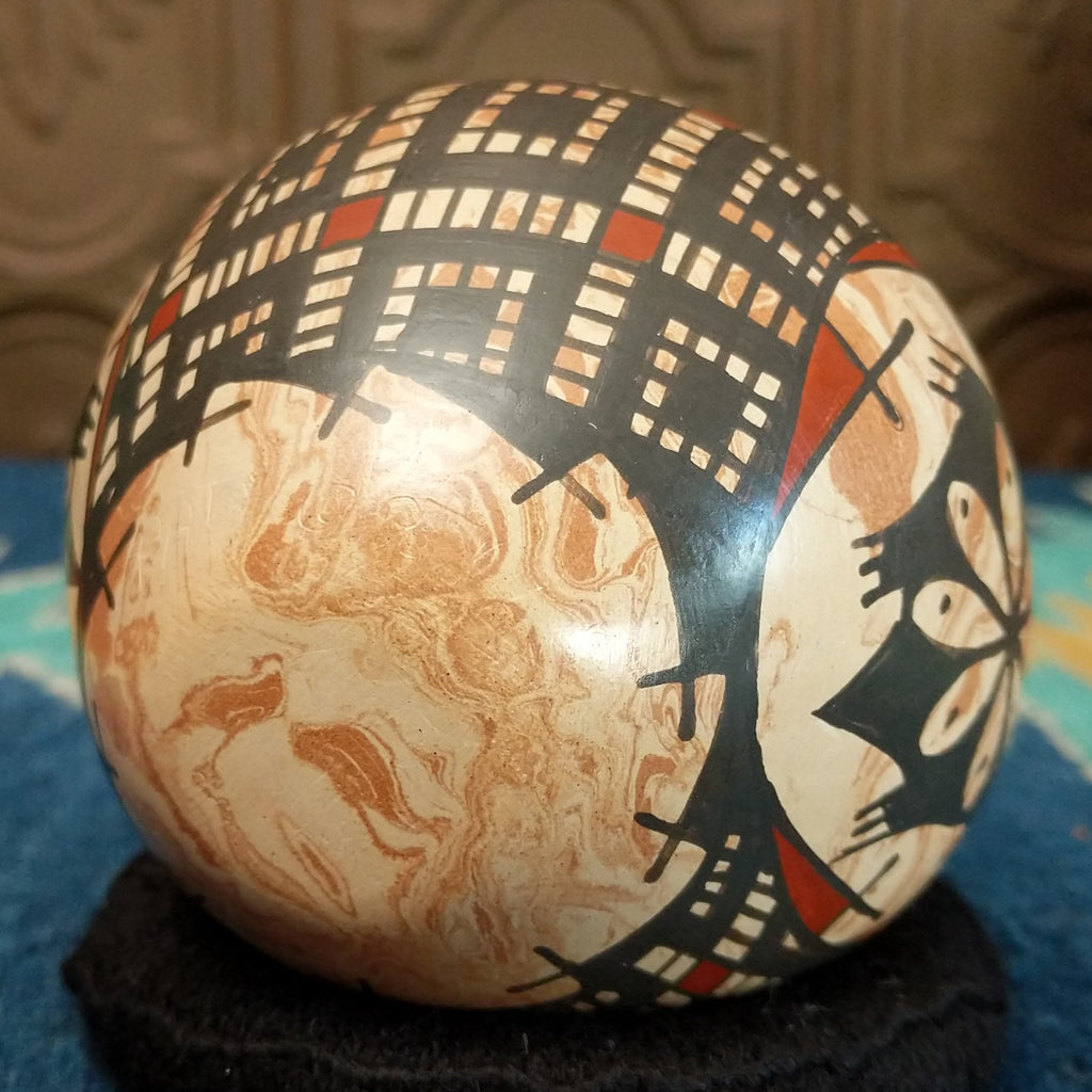 The underside of the pot features the signature.