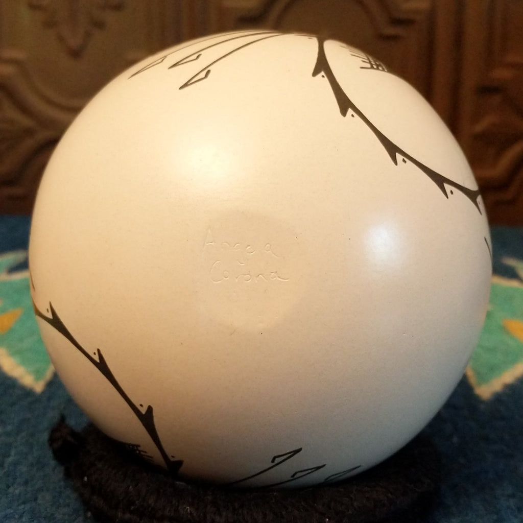 The underside of the piece showcases the artisan's signature.