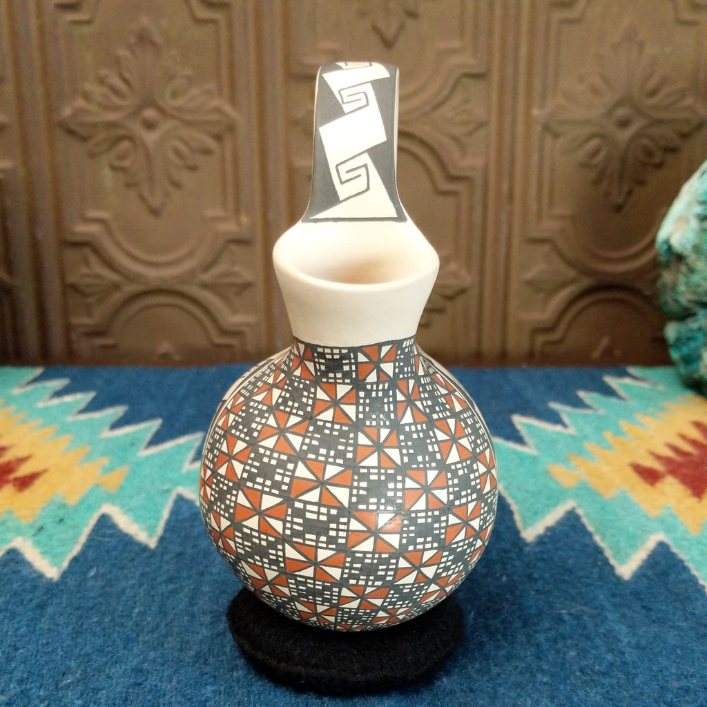 White clay wedding vase with traditionally colored geometric designs.
