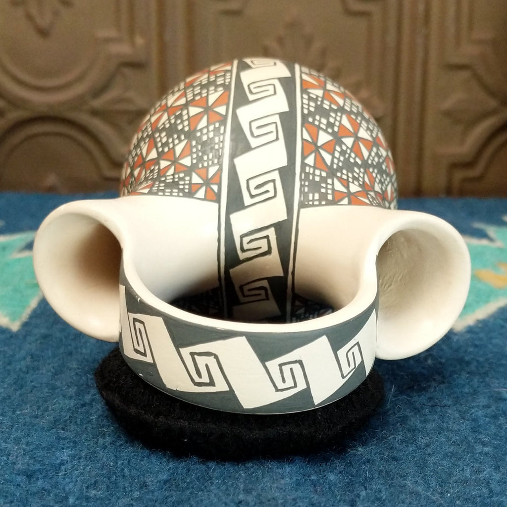 The top features the handle and two spouts.