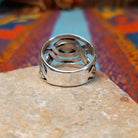 Meandering Lapis Ring by Raymond Coriz featuring an oval blue lapis stone set in Sterling Silver with flowing bands and detailed stamped silver accents; underside view.