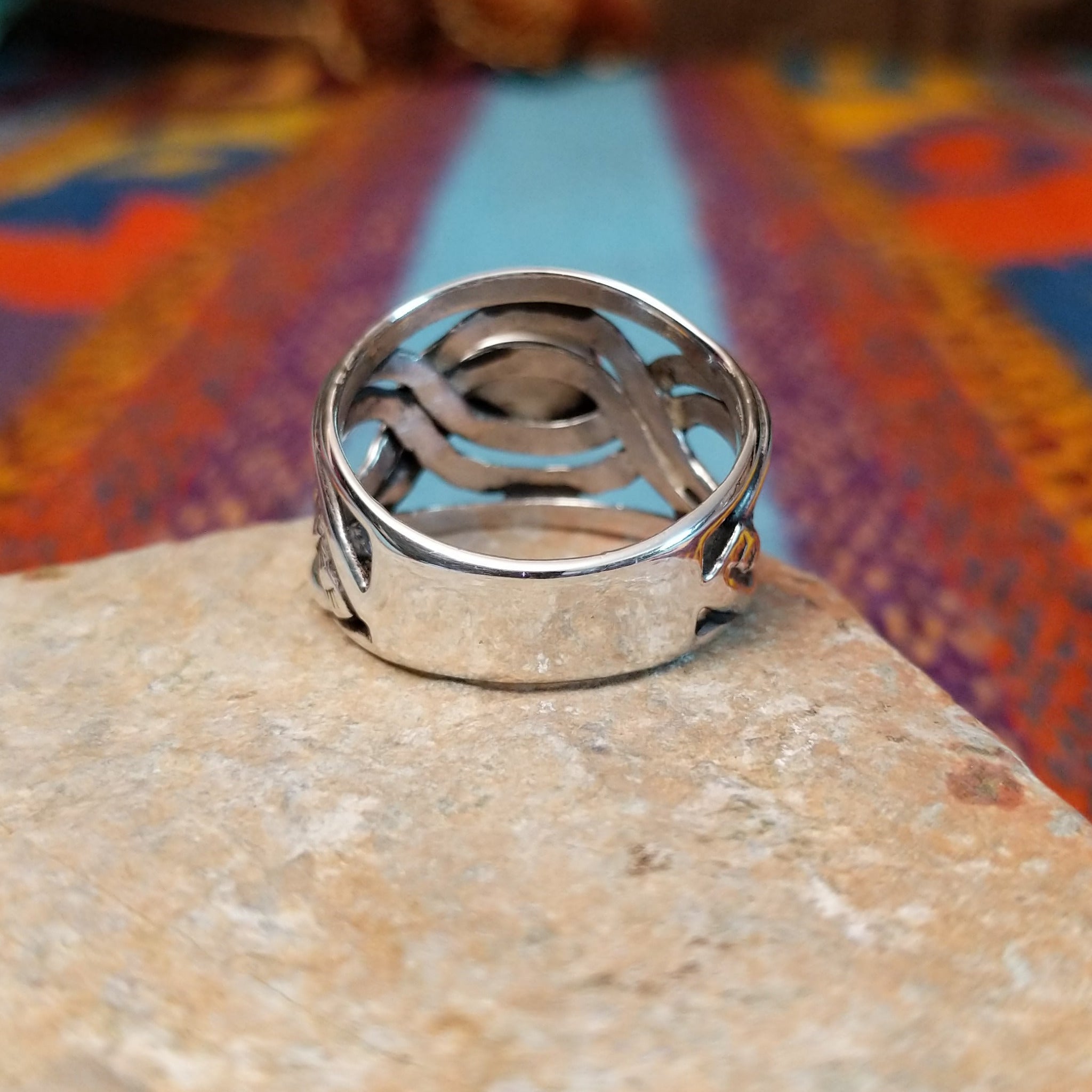 Meandering Lapis Ring by Raymond Coriz featuring an oval blue lapis stone set in Sterling Silver with flowing bands and detailed stamped silver accents; underside view.