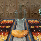 A glass cactus sculpture with translucent aqua glass mounted on a smooth sandstone base.