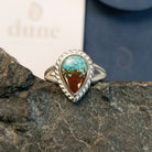 Mermaid ring with intricate band detailing featuring turquoise and Lake Powell sand set in the bezel.