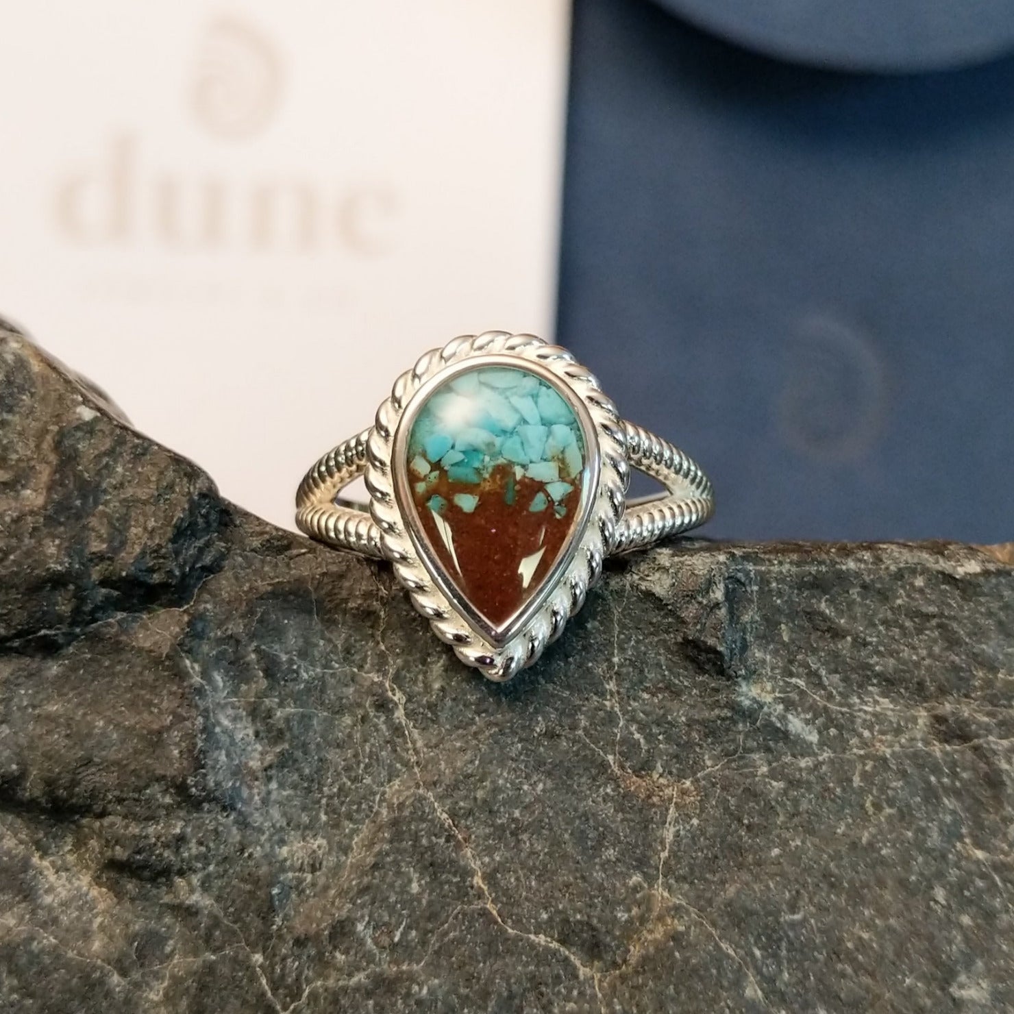 Mermaid ring with intricate band detailing featuring turquoise and Lake Powell sand set in the bezel.