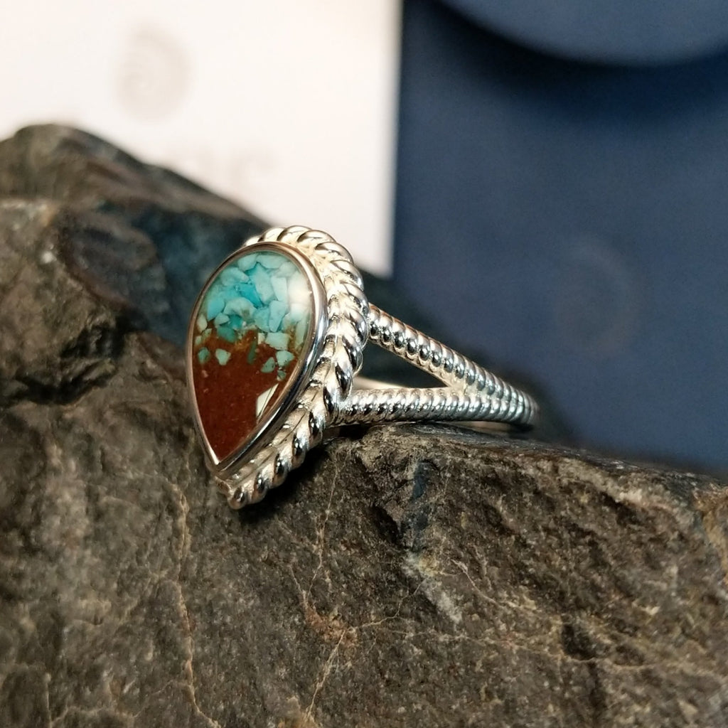 Mermaid ring with intricate band detailing featuring turquoise and Lake Powell sand set in the bezel.