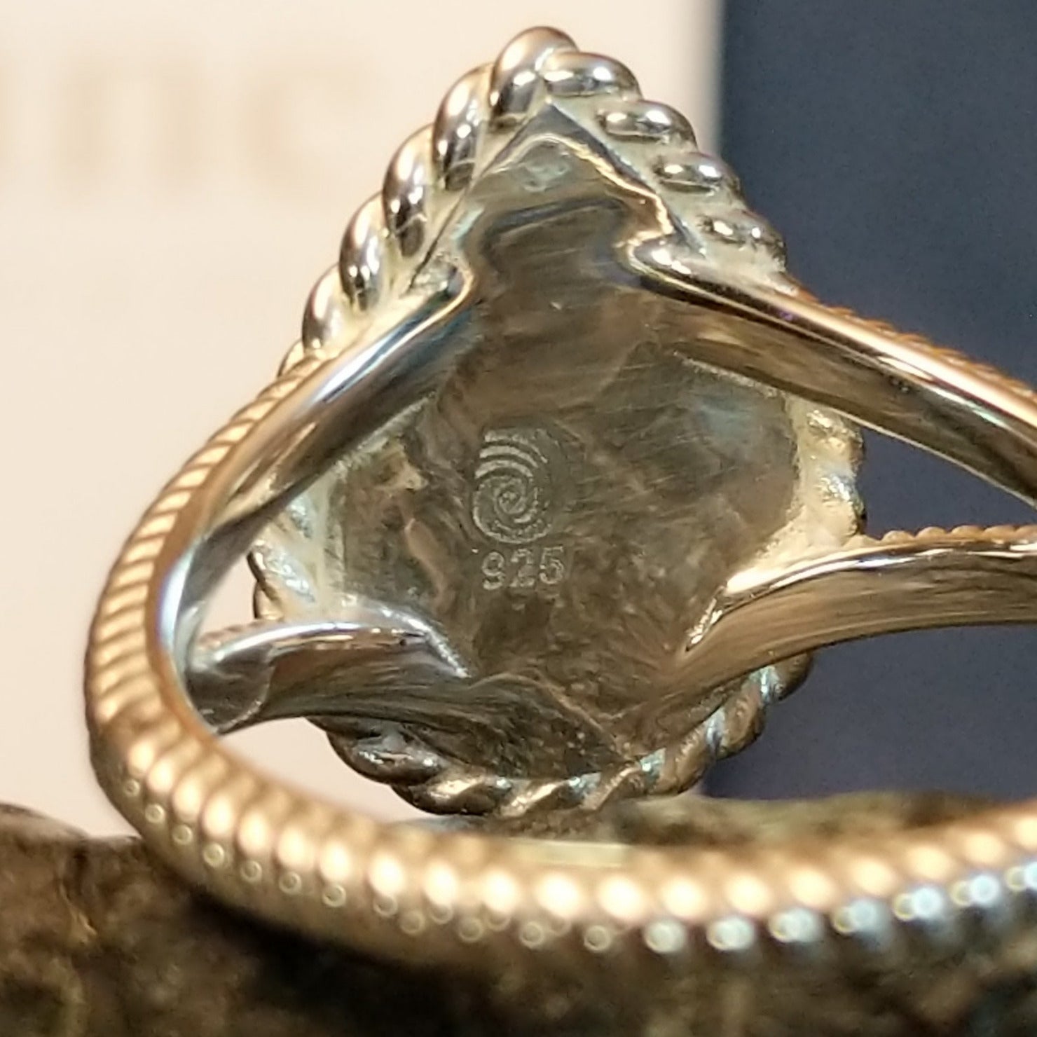 A close-up of the silver stamp and trademark.