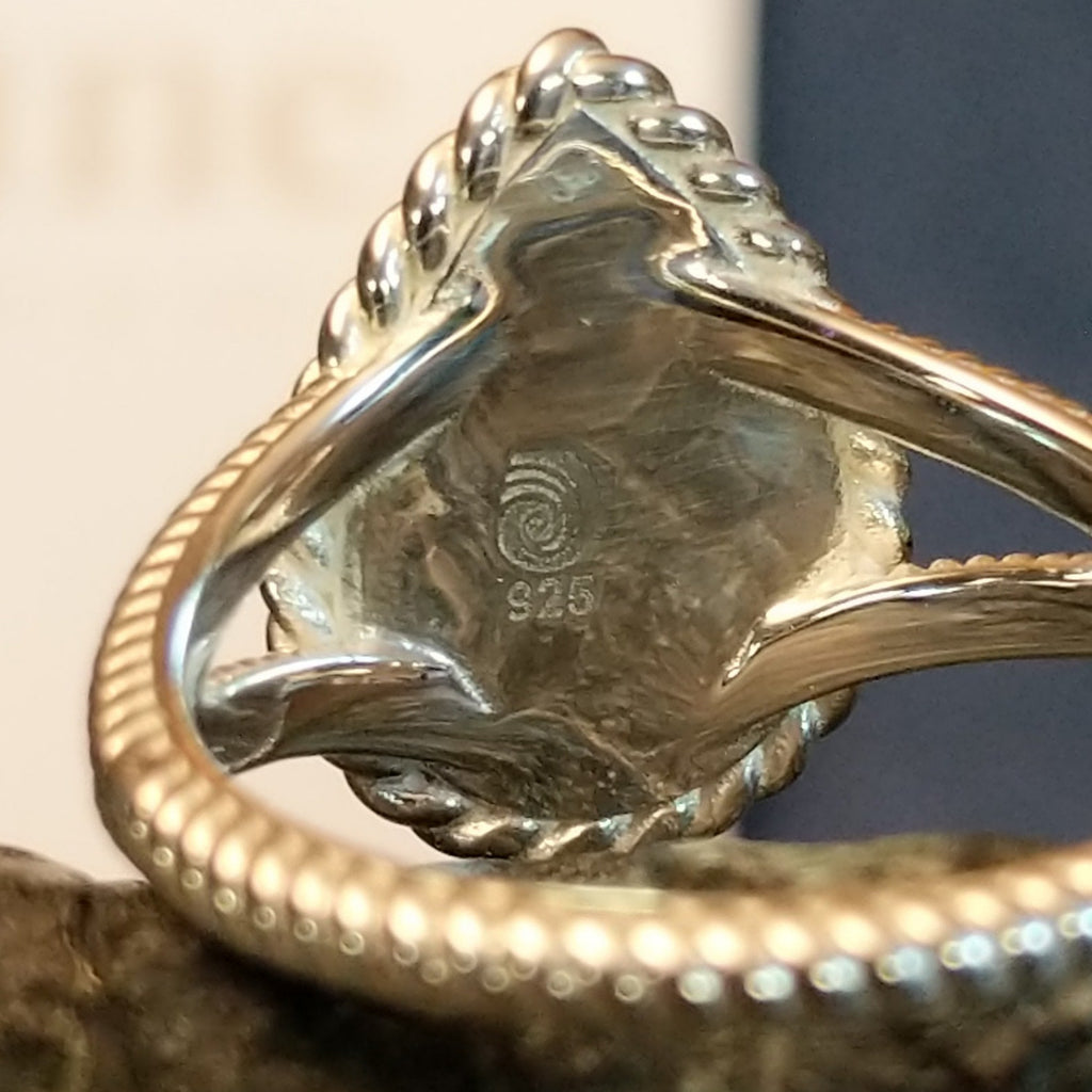 A close-up of the silver stamp and trademark.