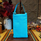 Mermaid Shimmer Club Bag by Bamboo Trading featuring an allover turquoise blue, silver, and gold beaded mermaid-scale pattern with shimmering metallic accents, a compact rectangular silhouette, and a coordinating turquoise blue shoulder strap; back view.