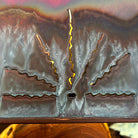 Cutout of sun rays on oxidized copper shade.