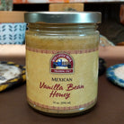 Jar of Mexican Vanilla Bean Honey made with pure honey infused with real Mexican vanilla bean. Golden honey with visible vanilla bean specks, ideal for sweetening beverages, desserts, and breakfast favorites.