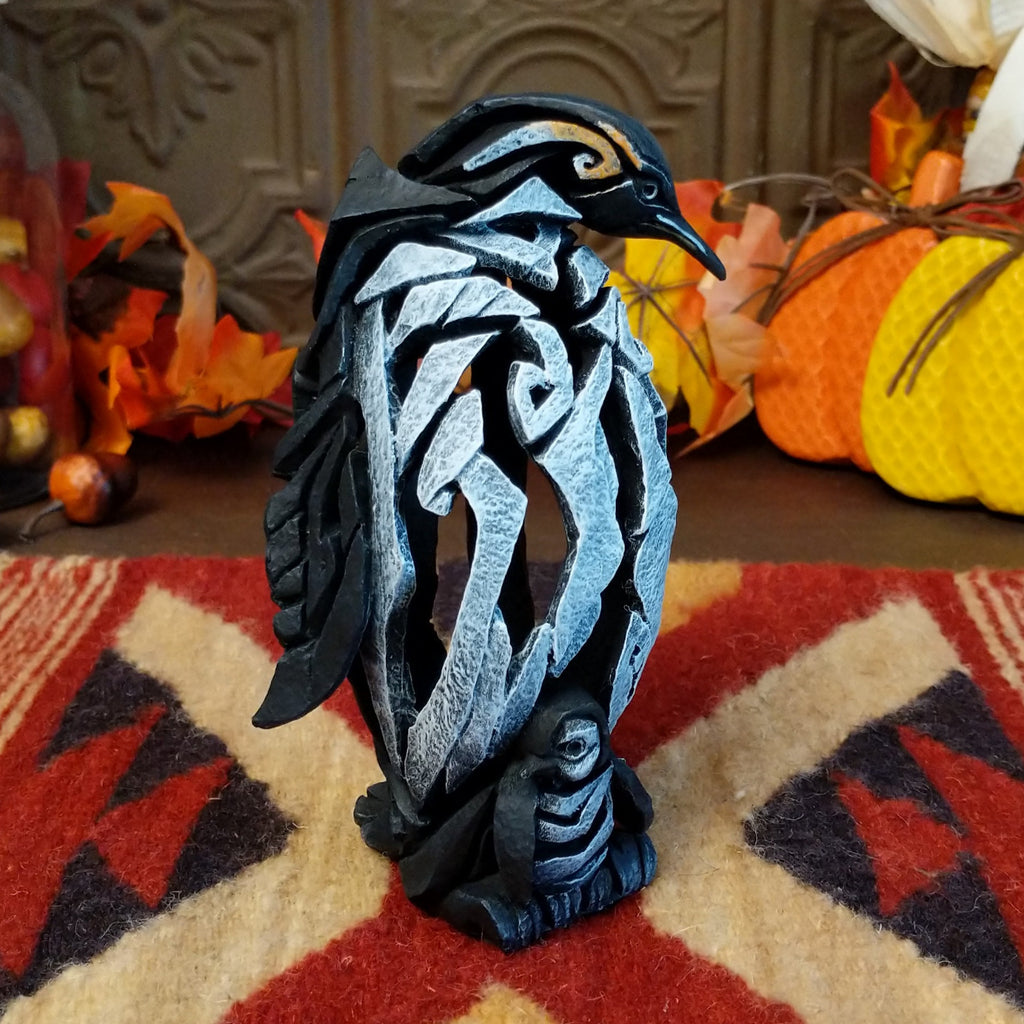 Cast marble used to create a penguin with a baby penguin at the feet.