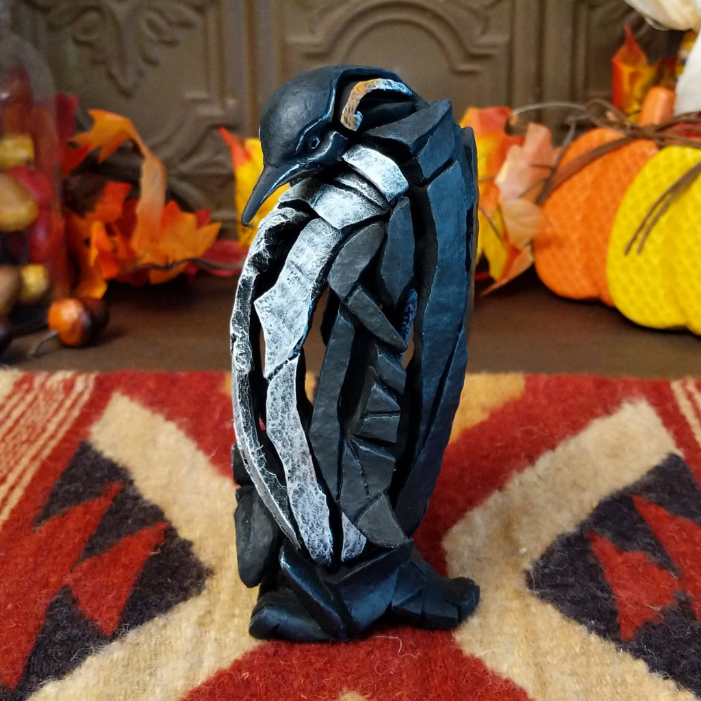 Cast marble used to create a penguin with a baby penguin at the feet.