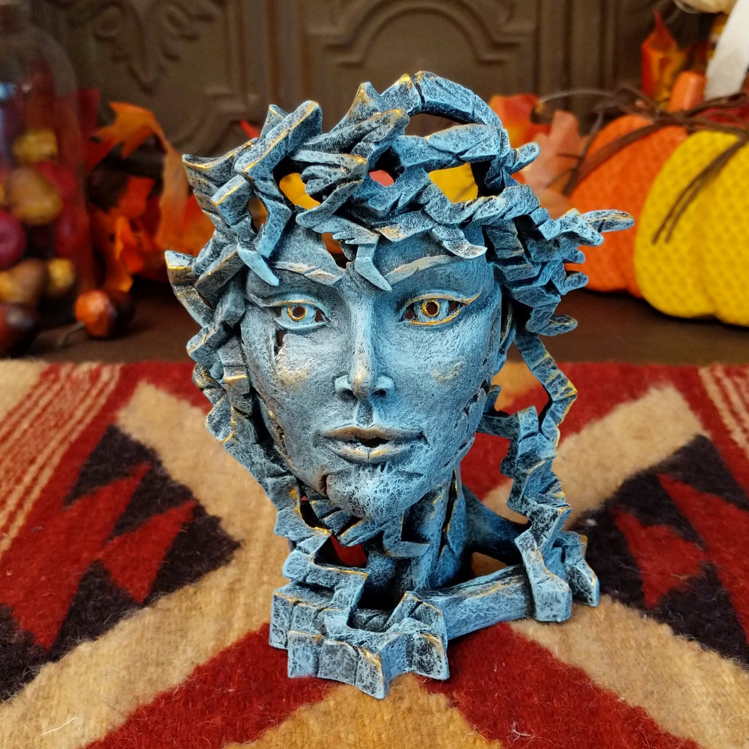 Cast marble creating an abstract face with detailed sculpting in the color gray.