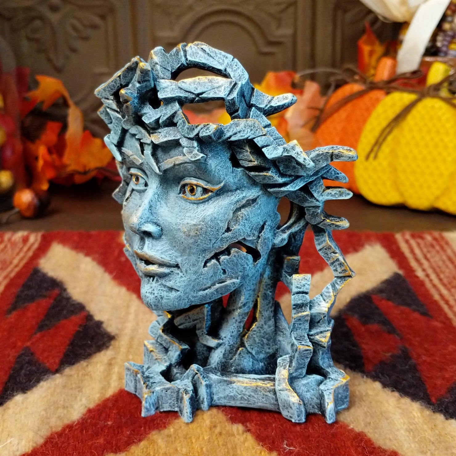 Cast marble creating an abstract face with detailed sculpting in the color gray.