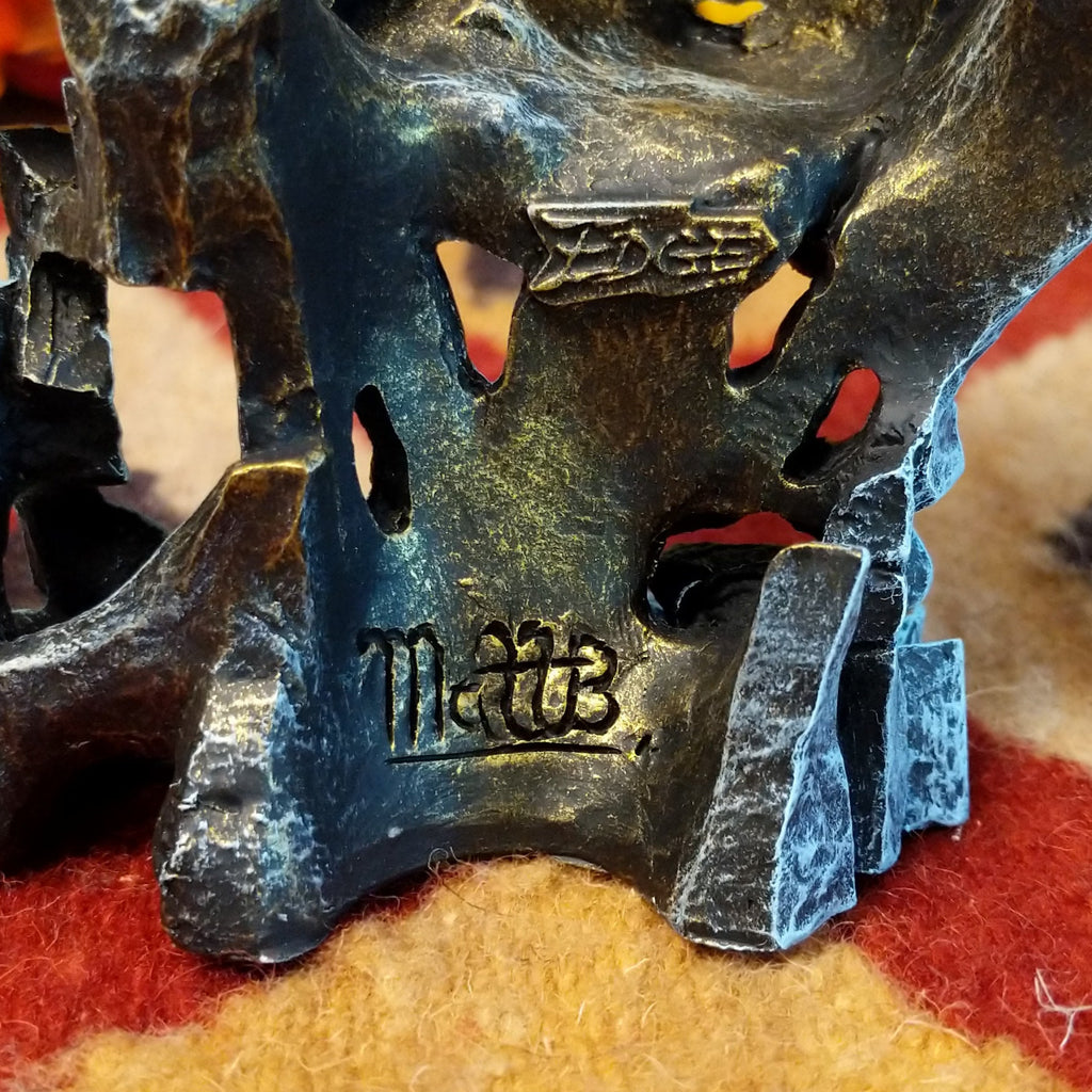 The artisan's signature is etched into the back of the piece.