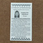 Close up of the Certificate of Authenticity and Artist information. 