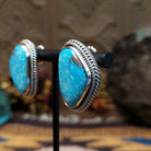 Sterling silver Morenci Turquoise stud earrings featuring freeform blue stones with natural matrix and twisted rope detailing.