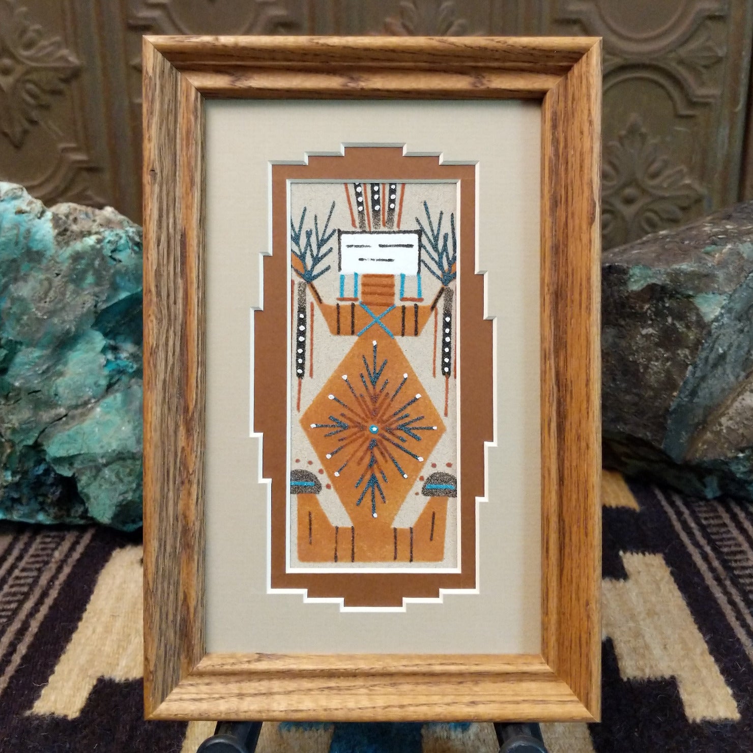 Framed Navajo sand painting of Mother Earth with plant and earth motifs. 