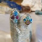 Sterling silver bracelet with Austrian crystals set in floral bezels.