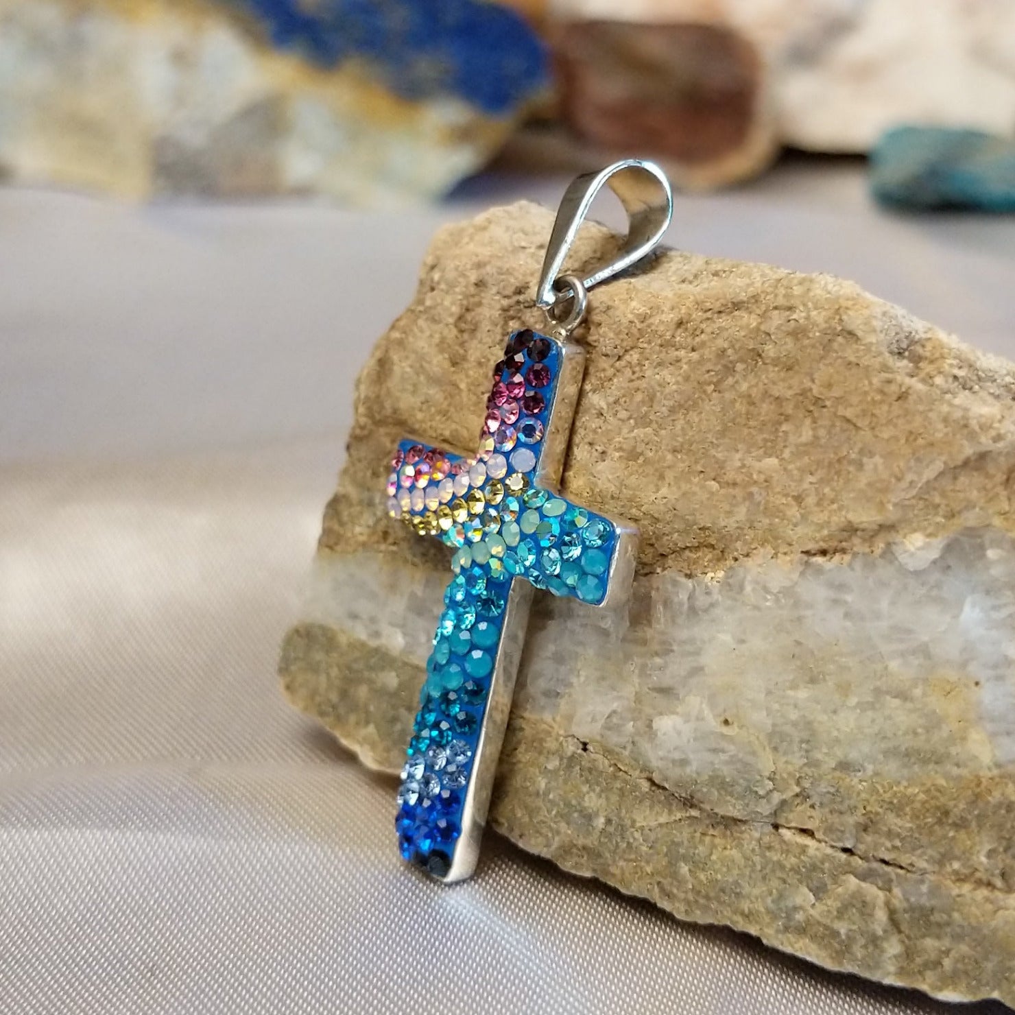 Sterling silver cross pendant with multicolored Austrian crystals.