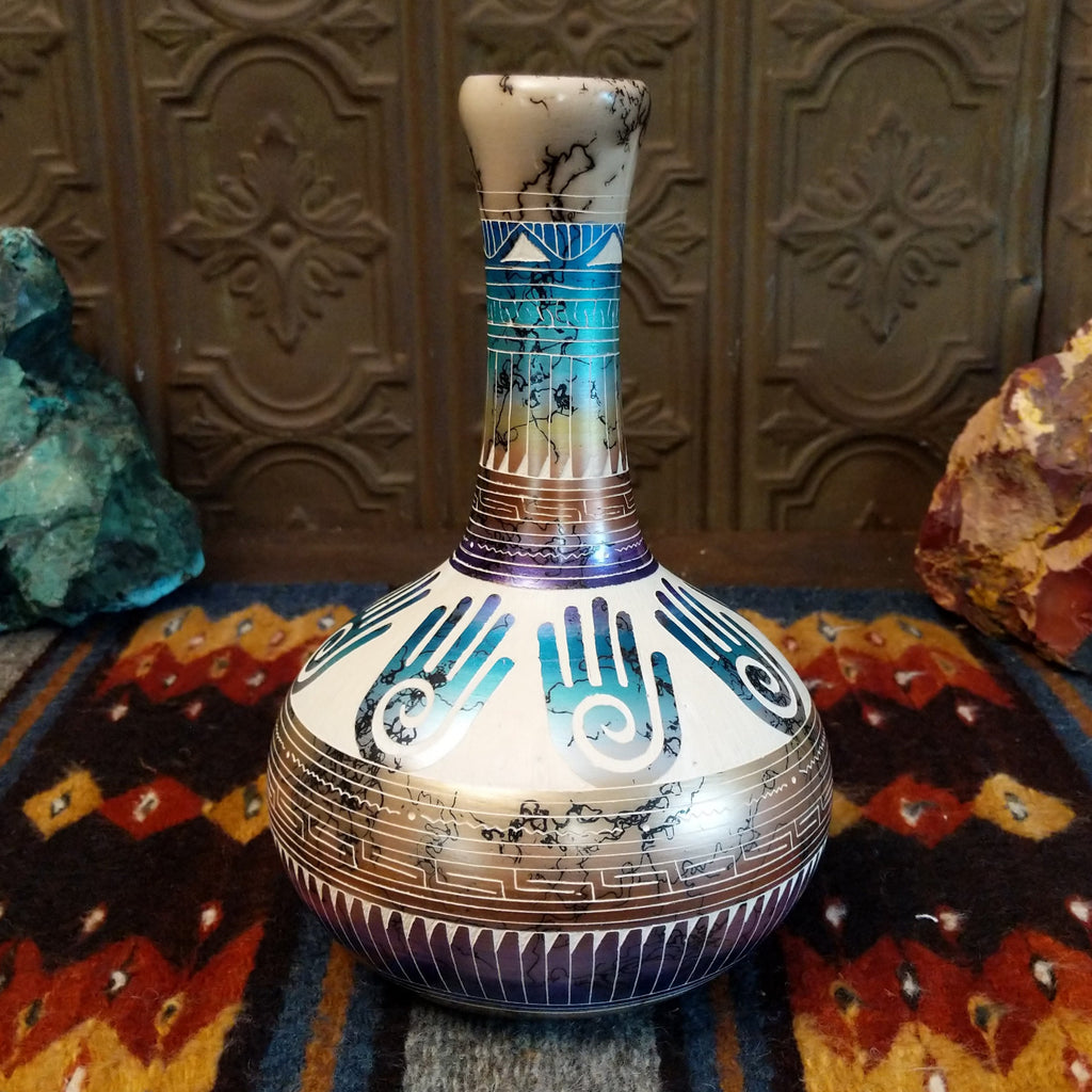 Multicolor Hamsa hand pottery with white clay, blue, purple, and gold gradients.