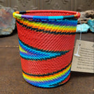 Handwoven multicolor wire art cup by Bridge for Africa featuring vibrant recycled wire in a colorful diagonal pattern, ideal as a decorative container, utensil holder, or pencil cup.
