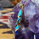 14kt gold Steve Francisco navette pendant with elongated geometric multistone inlay.