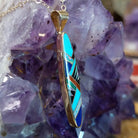 14kt gold Steve Francisco navette pendant with elongated geometric multistone inlay.
