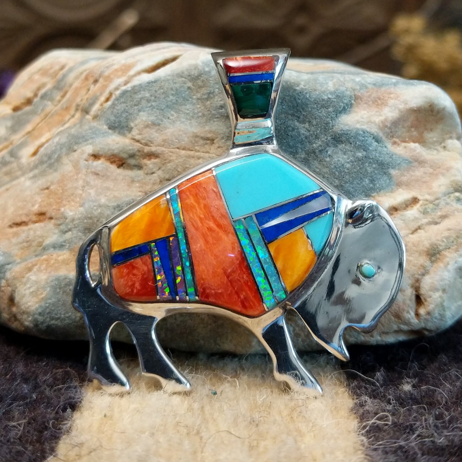 Sterling silver buffalo pendant with multistone inlay.