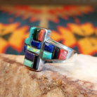 Chunky sterling silver ring featuring multi-stone inlays.